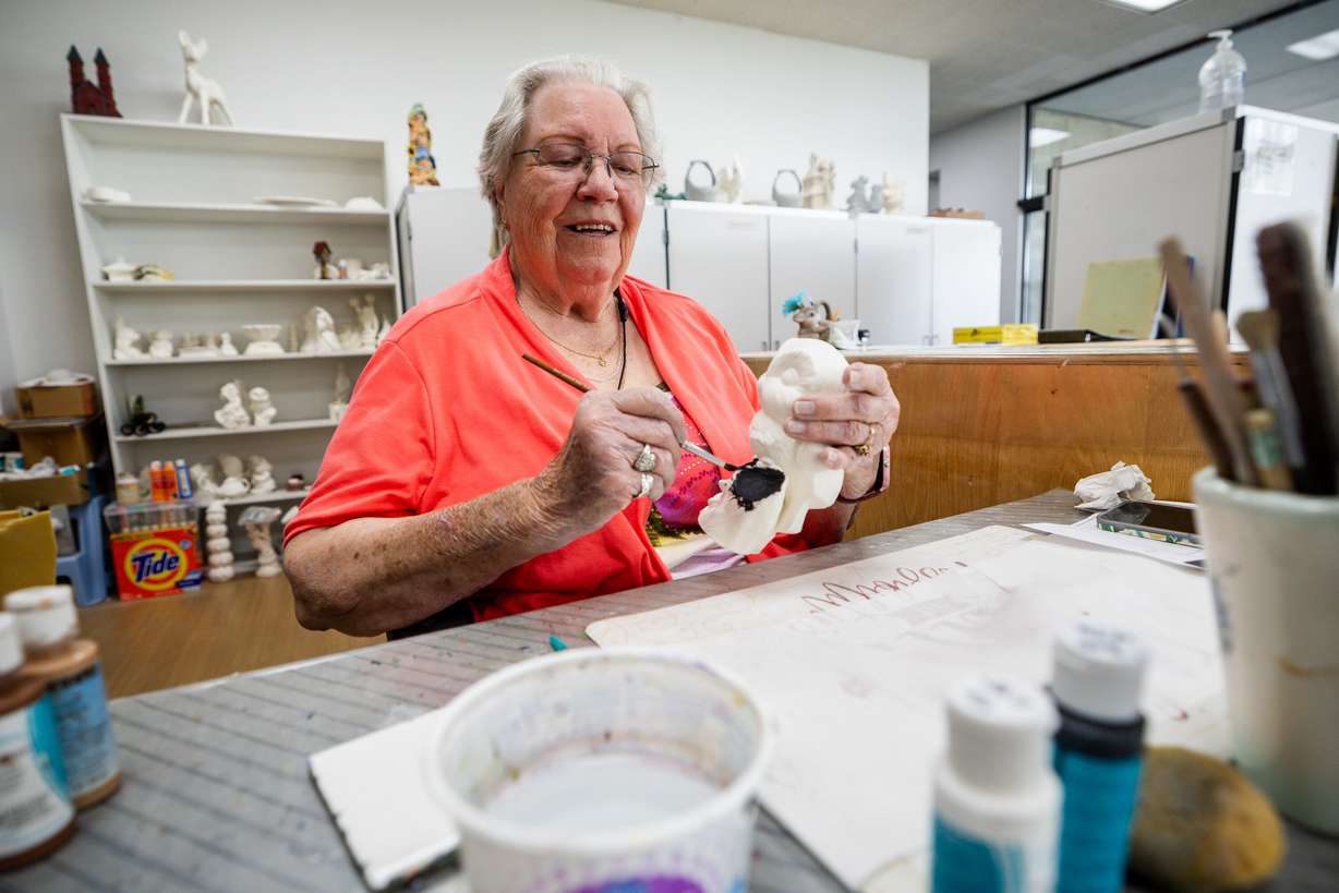 JoAnn Nielsen paints an owl during a senior ceramics class at the Murray City Senior Recreation Center on Thursday. Nielsen said being happy is about having the right attitude.