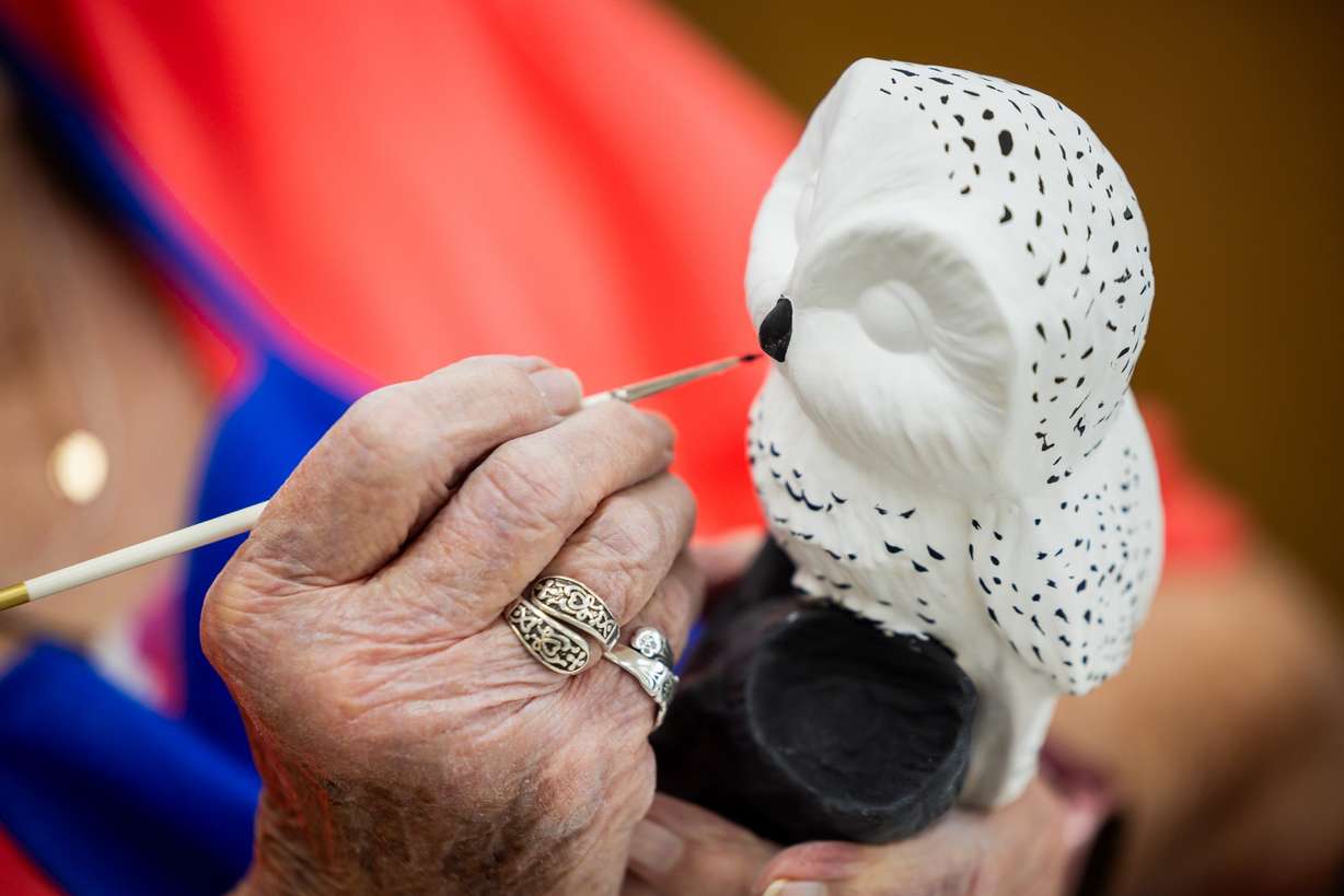 JoAnn Nielsen paints an owl during a senior ceramics class at the Murray City Senior Recreation Center on Thursday. Nielsen said being happy is about having the right attitude.