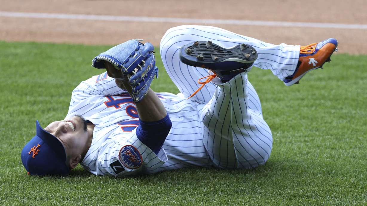 New York Mets pitcher Kodai Senga reacts after an apparent injury during the sixth inning of a baseball game against the Washington Nationals, Thursday, June 12, 2025, in New York.