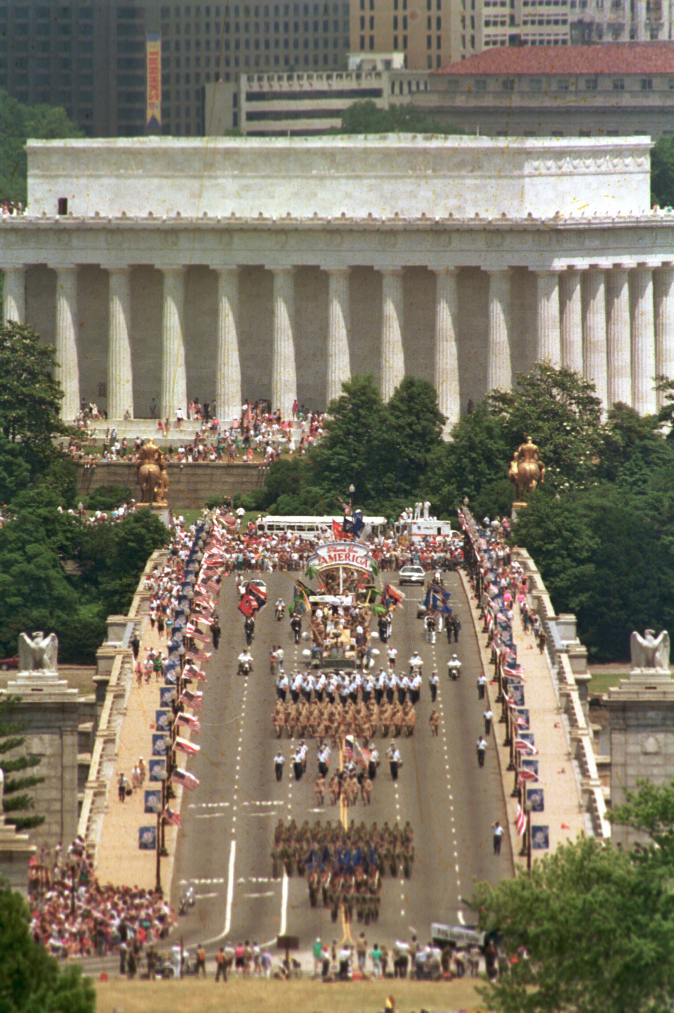 This view, taken from Arlington National Cemetery, shows troops marching across the Memorial Bridge, with the Lincoln Memorial in the background, in Washington, heading toward the Pentagon during the National Victory Day Parade, June 8, 1991. The celebration to honor Gulf War troops drew an estimated 800,000 spectators.