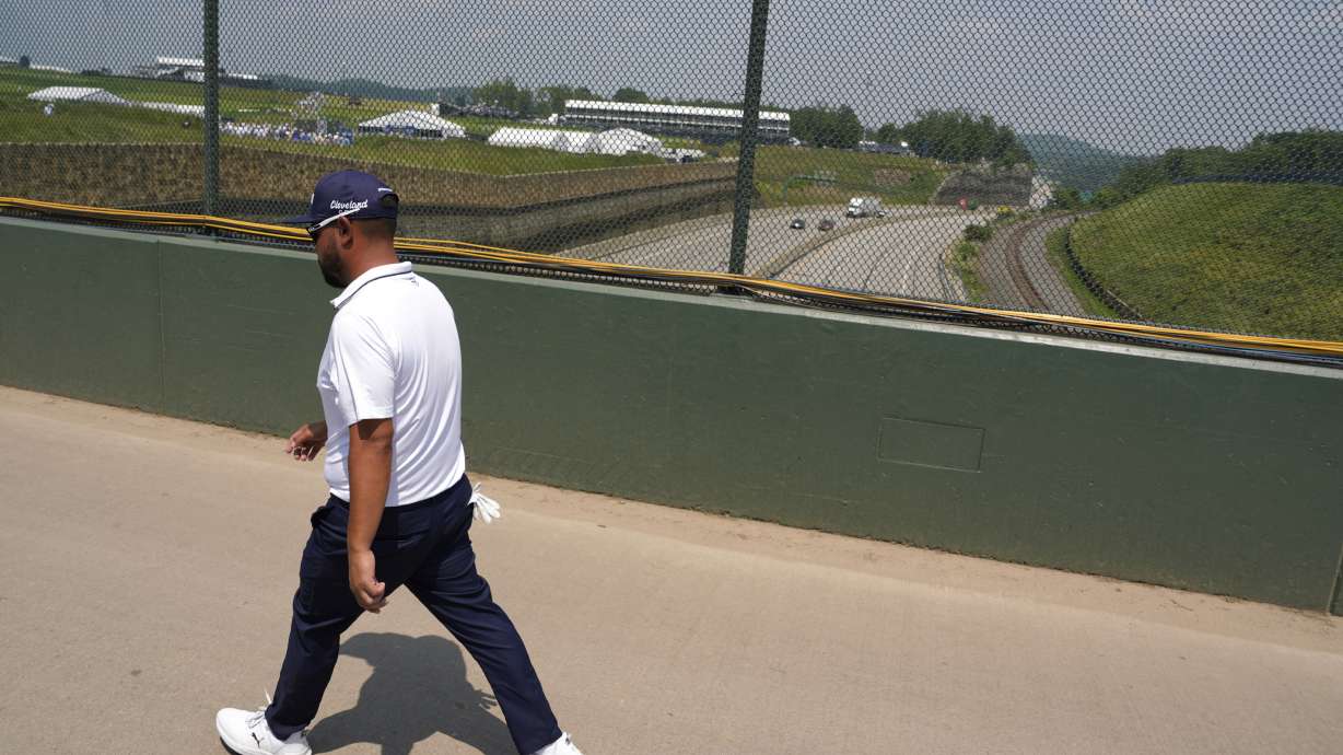 J.J. Spaun walks across a bridge over the Pennsylvania Turnpike, which runs through Oakmont Country Club, during the first round of the U.S. Open golf tournament Thursday, June 12, 2025, in Oakmont, Pa.