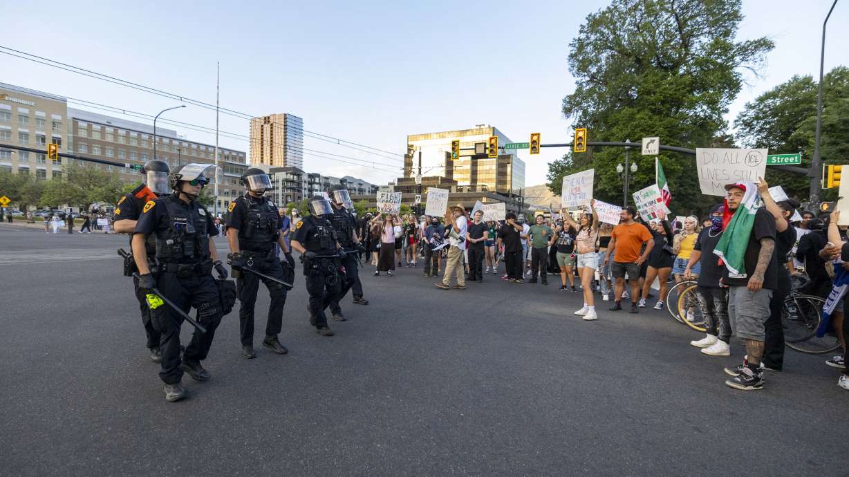 Salt Lake police officers confront protesters during an anti-ICE protest in downtown Salt Lake City, June 12. A clash between protesters and counterprotesters that day resulted in charges for a Centerville man who allegedly punched two people.