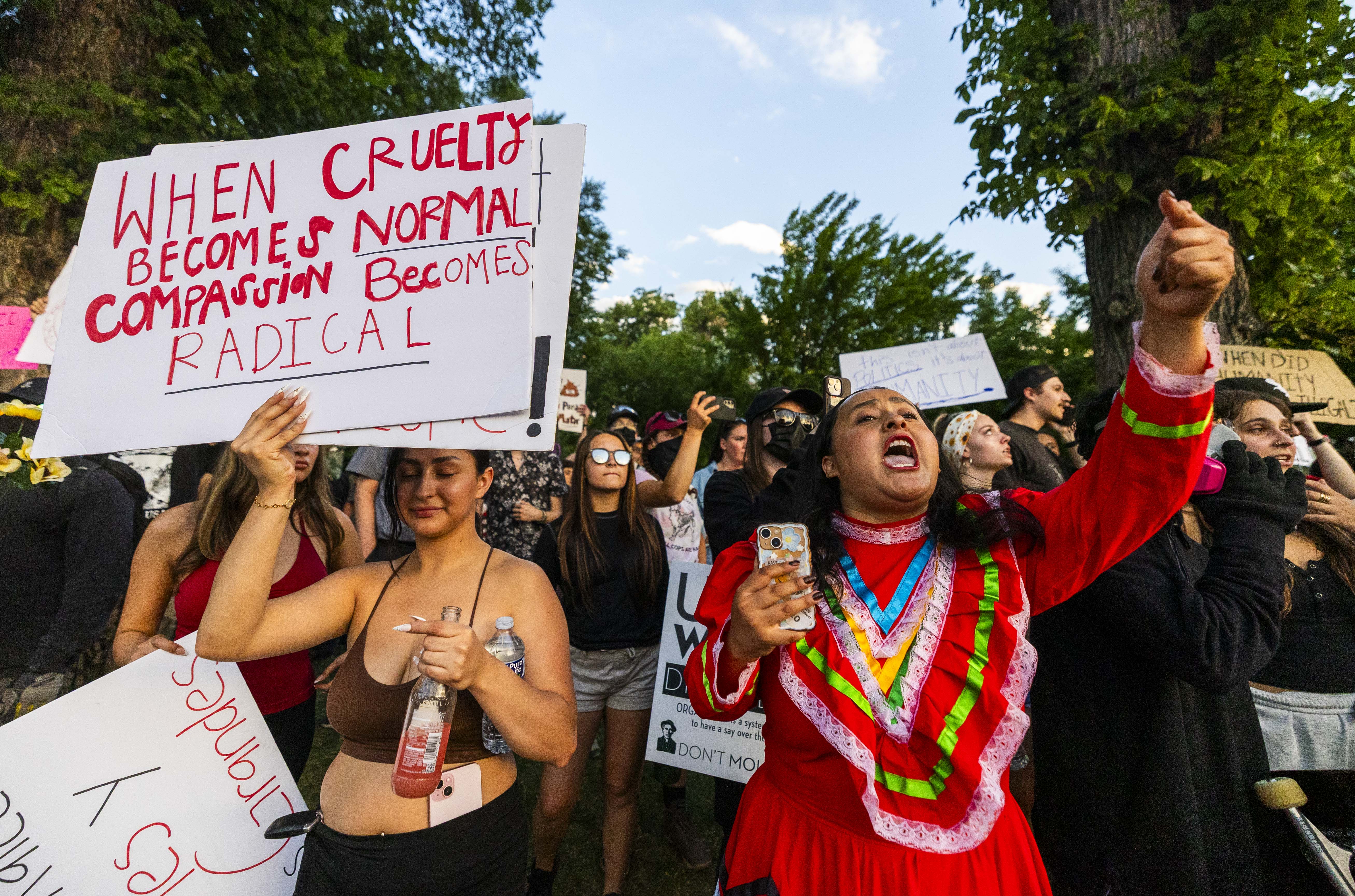 Jaz Dumas, right, yells at a line of police officers during an anti-ICE protest in downtown Salt Lake City on June 12. The debate over immigration was intense in 2025, and more of the same is likely in 2026.