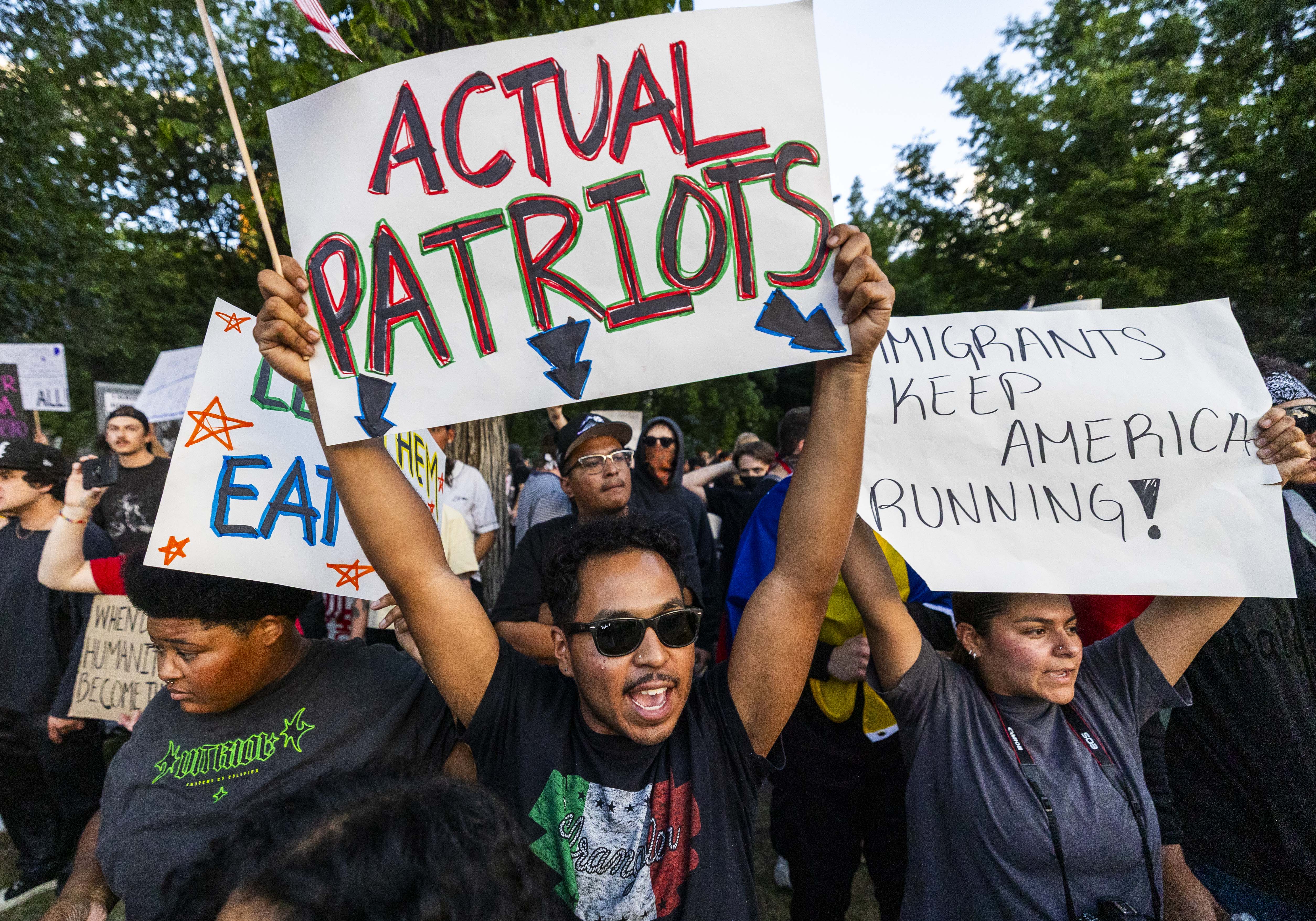 Jesus Bernal holds up a sign and chants with other protesters during an anti-ICE protest in downtown Salt Lake City on Thursday.