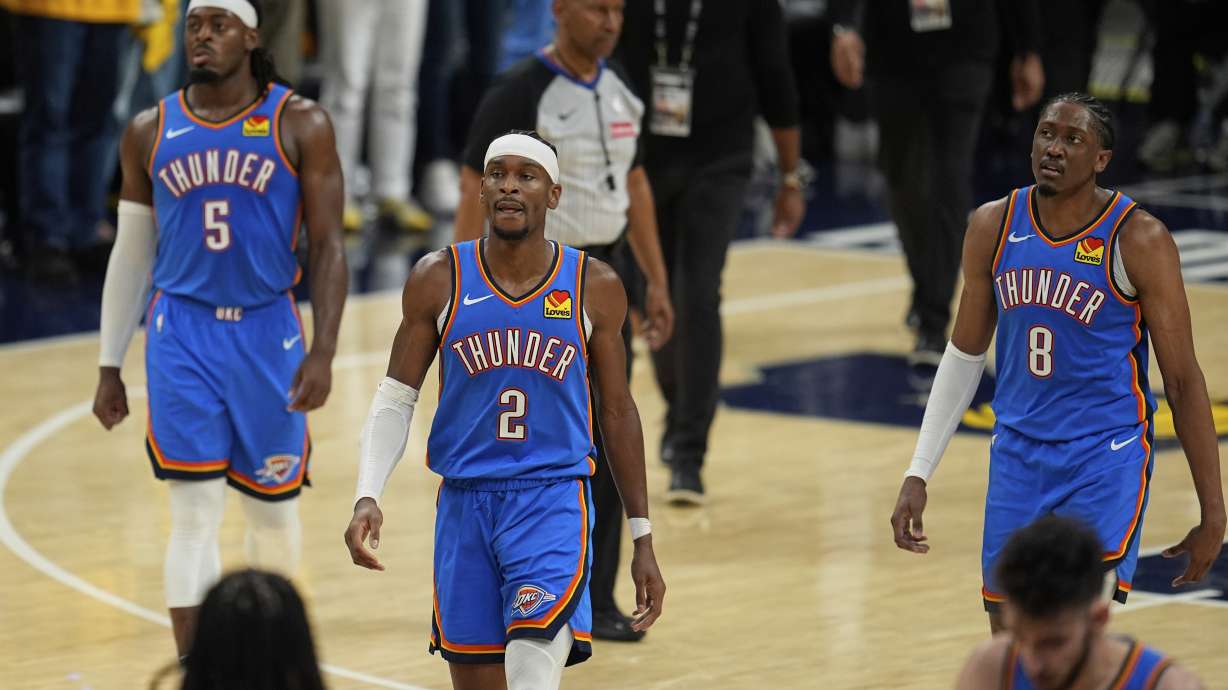 Oklahoma City Thunder guard Shai Gilgeous-Alexander (2), guard Luguentz Dort (5) and forward Jalen Williams (8) walk the their bench during the second half of Game 3 of the NBA Finals basketball series against the Indiana Pacers, Wednesday, June 11, 2025, in Indianapolis.