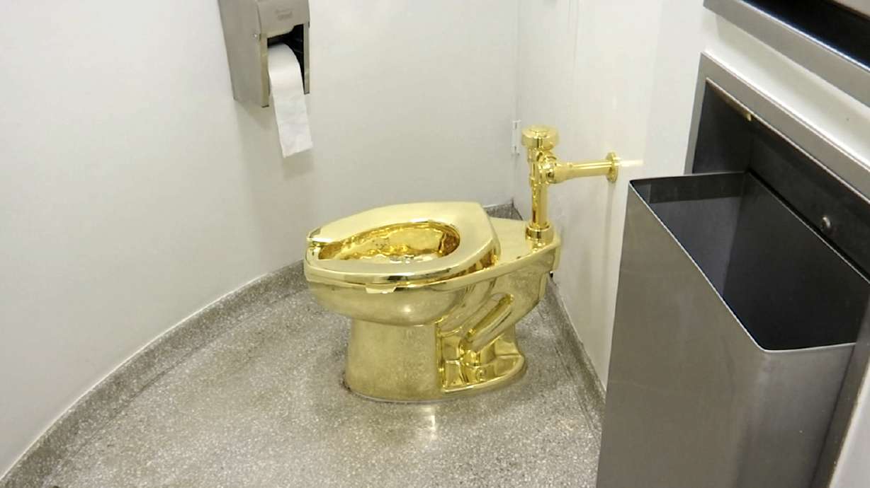 Two burglars who plotted the heist of an 18-karat, $6.4 million golden toilet were sentenced to more than two years in prison Friday.
