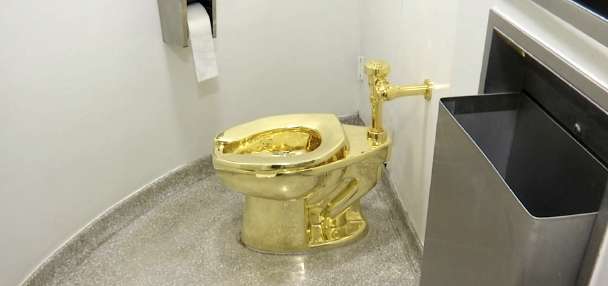 Men who stole $6M golden toilet from English mansion sentenced to prison terms