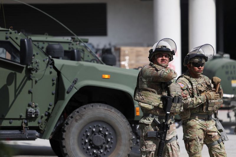 Members of the National Guard stand guard outside the Edward R. Roybal Federal Building in Los Angeles, June 13. The Pentagon ordered the removal of 2,000 National Guard members from the city on Tuesday.
