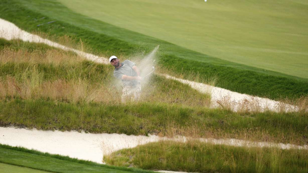 Scottie Scheffler plays out of the Church Pews bunker on the third hole during the second round of the U.S. Open golf tournament at Oakmont Country Club Friday, June 13, 2025, in Oakmont, Pa.