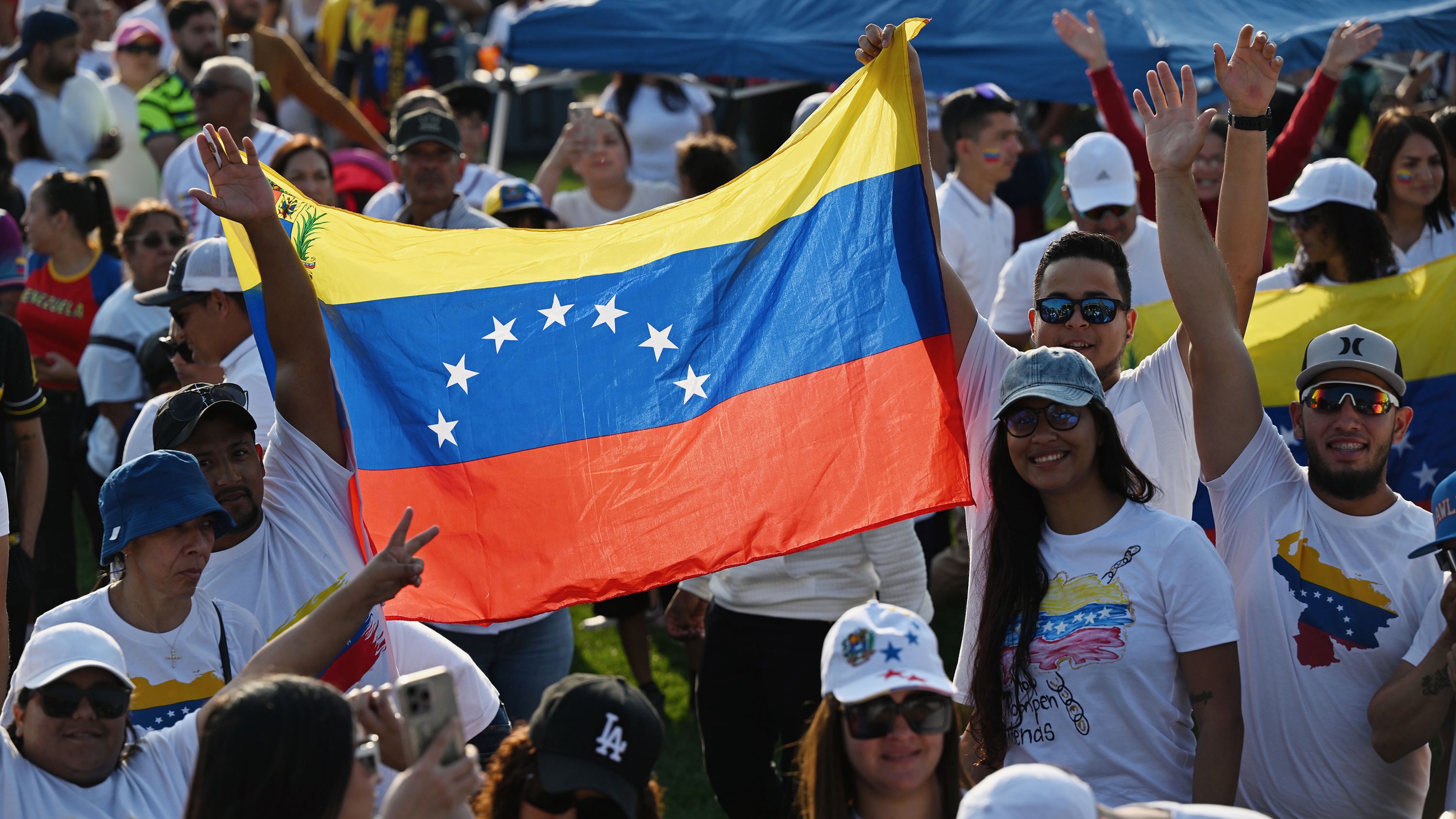 Members of the Venezuelan community with a Venezuelan flag in Herriman on July 28, 2024, as they mark elections in their home country. As President Trump presses to remove humanitarian parolees, some in Utah from Venezuela have already left.