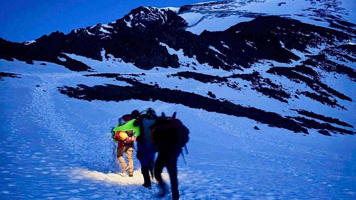 Alpine Rescue Team members take part in helping get two men struck by lightning off Torreys Peak in Colorado, Thursday.