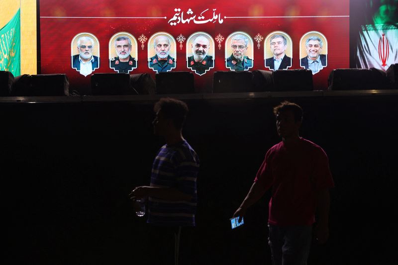 Pictures of those killed in Israeli strikes on Iran are displayed on a street in Tehran, Friday. Iranian U.N. envoy Amir Saeid Iravani said several senior military officials were among the 78 killed in the strikes.