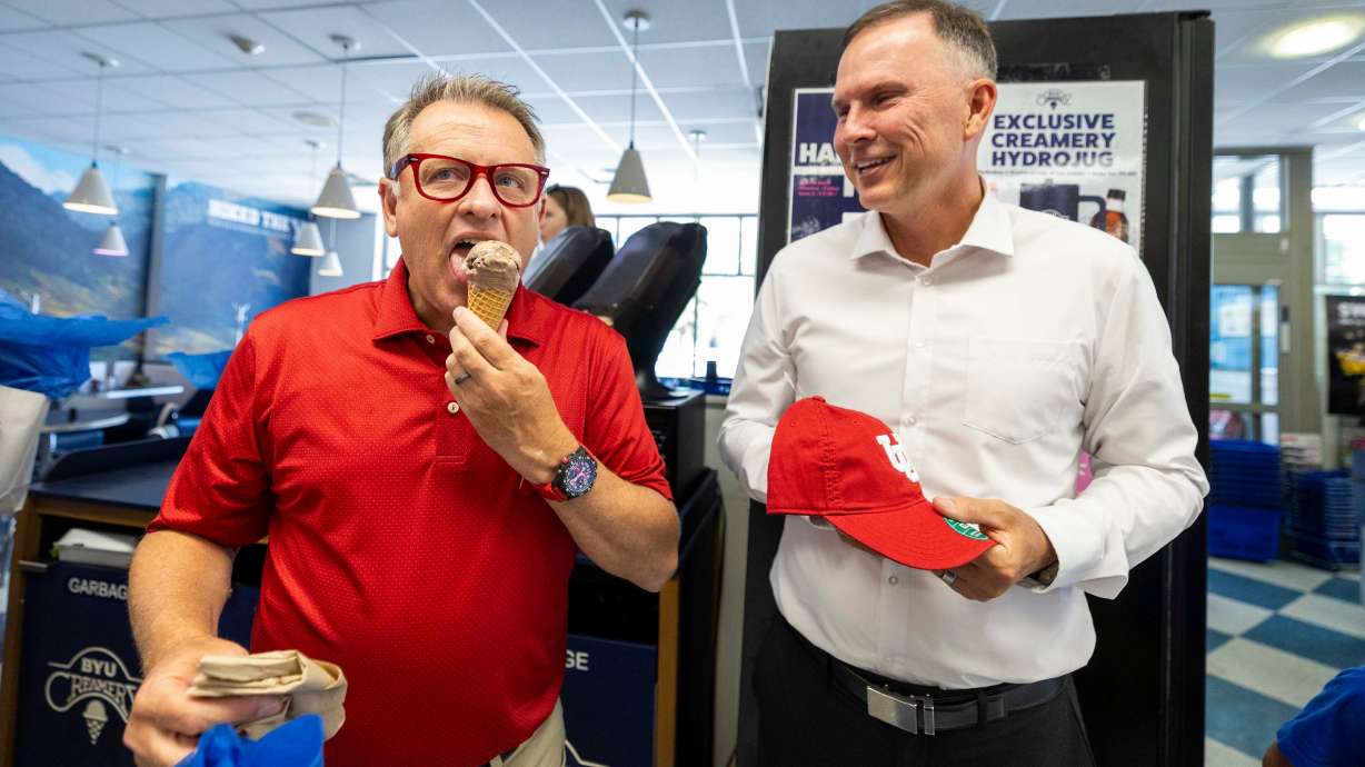 University of Utah President Taylor Randall tries a cone of “In-Shane-ly Chocolate” ice cream, a flavor named after BYU President C. Shane Reese, during a visit BYU Creamery in Provo on Friday.