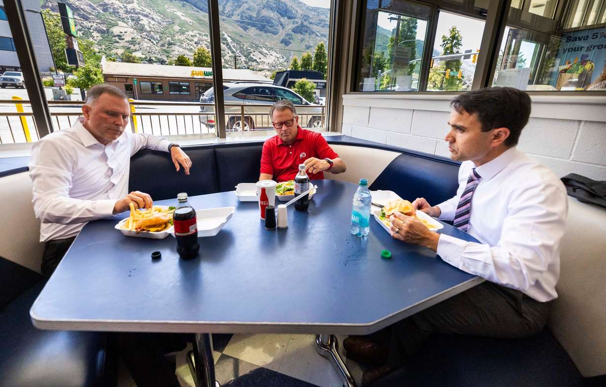 BYU Administrative Vice President Steve Hafen, University of Utah President Taylor Randall and BYU Academic Vice President Justin Collings, talk with each other over lunch during a visit at the BYU Creamery in Provo on Friday.