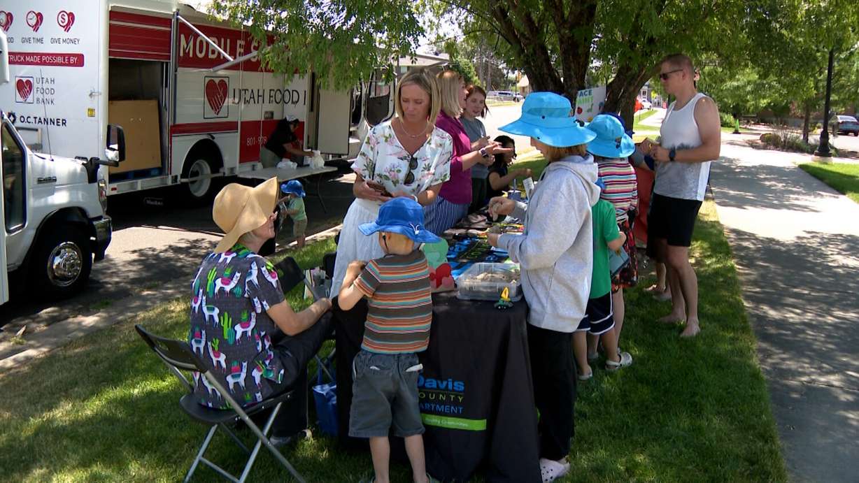 Davis County Health Department employees interact with families at Heritage Park in Kaysville Friday. The visit is part of a department initiative to make families in the county aware of services available to them.