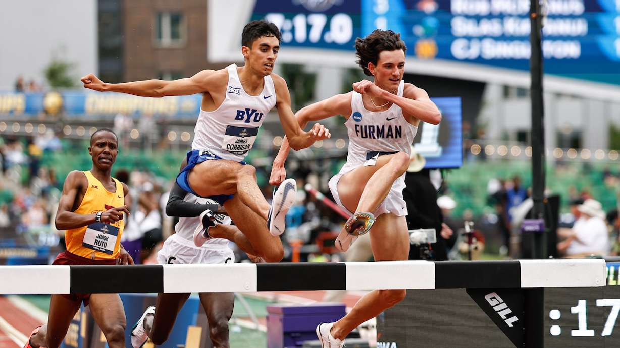 BYU's James Corrigan, shown here leaping over a barrier with Furman's Carson Williams, finished first in the 3,000-meter steeplechase in 8:16.41 to win a national title at the 2025 NCAA outdoor track and field championships in Eugene, Oregon.