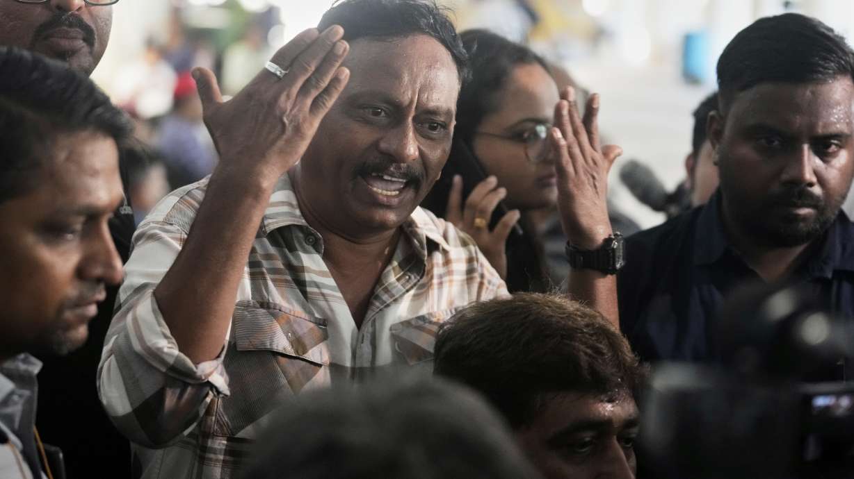 Ayub sheikh gestures angrily as he waits for the bodies of four relatives who died in the Air India plane crash, at a hospital in Ahmedabad, India, Saturday.