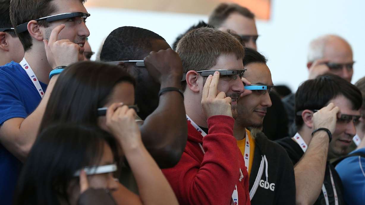 Attendees wear Google Glass while posing for a group photo during the Google I/O developer conference on May 17, 2013, in San Francisco.