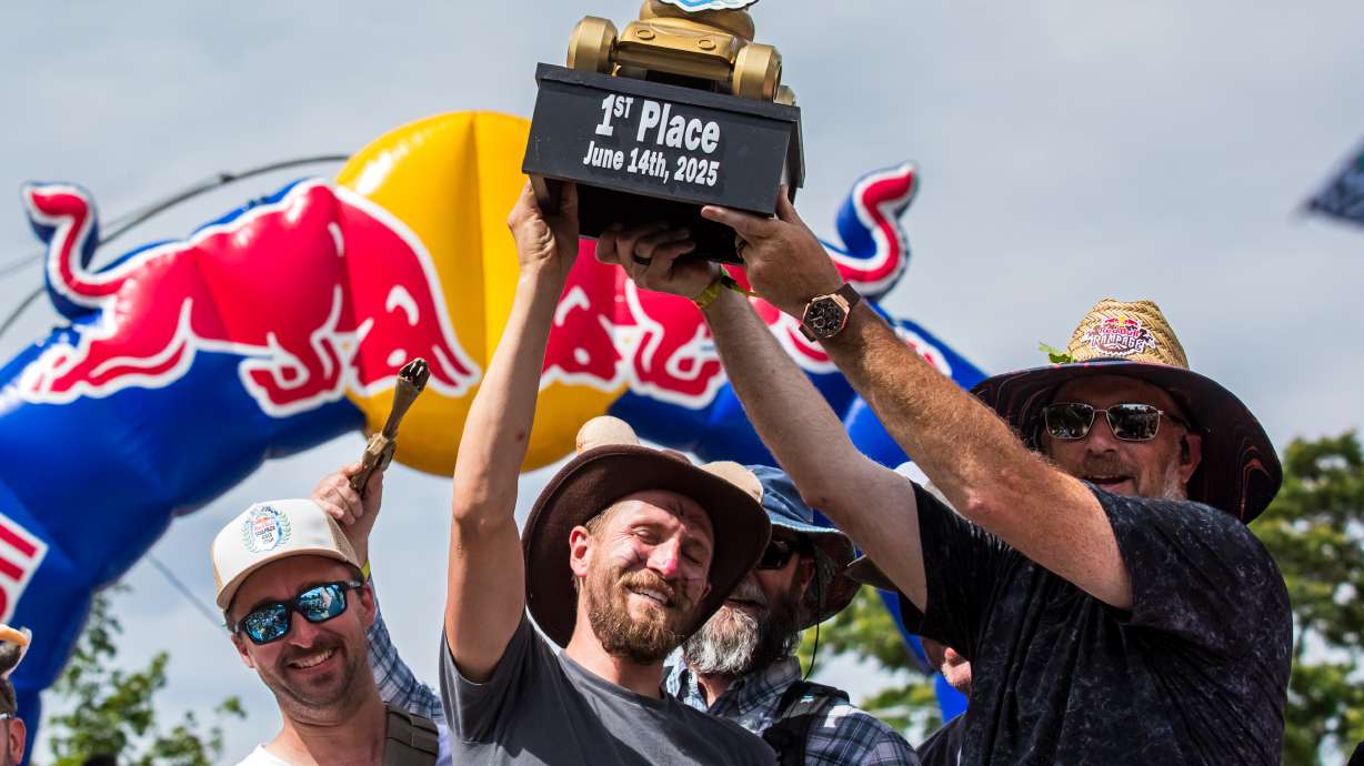 Members of the "The Desert Rats" hoist the first place trophy after winning the Red Bull Soapbox Race in Salt Lake City on Saturday. The event drew about 50,000 people in its first time ever being held in Utah.