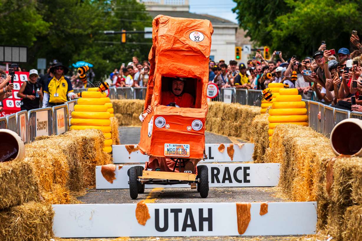 Isaac Dushku, a member of the team "Delicate For" from Centerville, holds his Delicate Arch-themed vehicle together while driving down the Red Bull Soapbox Race course in Salt Lake City on Saturday.