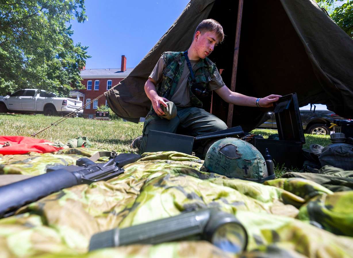 James Secrist, portraying a Vietnam-era member of the 101st Airborne, goes through his gear during a celebration of the U.S. Army’s 250th birthday at Fort Douglas in Salt Lake City on Saturday. The celebration was held as a massive military parade took place in Washington.