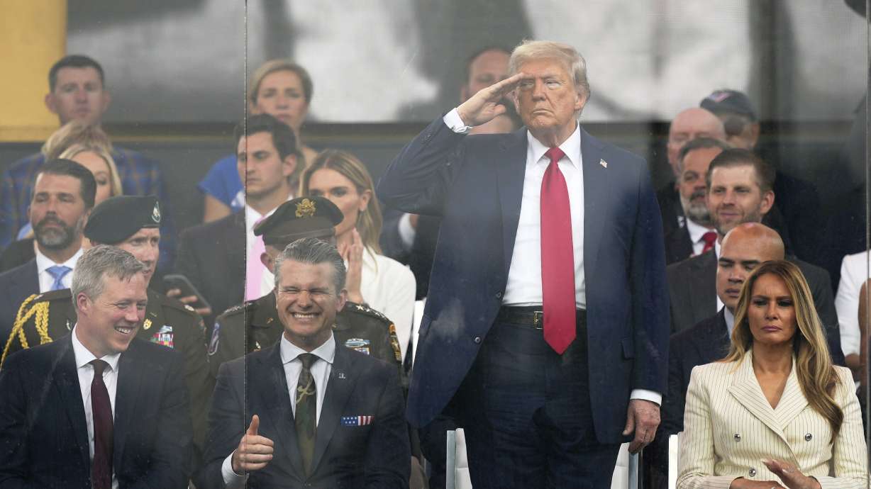 President Donald Trump salutes at a military parade commemorating the Army's 250th anniversary, coinciding with his 79th birthday, Saturday, in Washington. The parade was marred by a day of violence and discord.