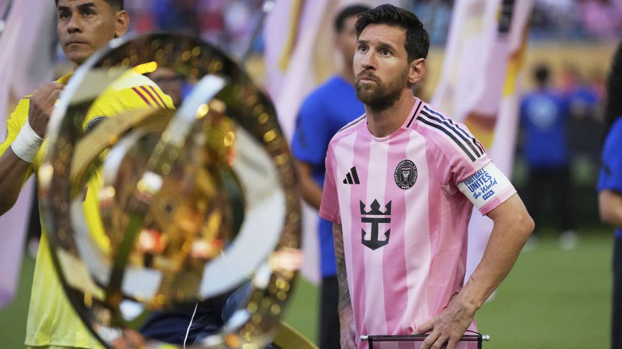 Inter Miami's Lionel Messi, right, and goalkeeper Oscar Ustari stand next to the trophy prior to the Club World Cup group A soccer match between Al Ahly and Inter Miami in Miami, Fla., Saturday, June 14, 2025.