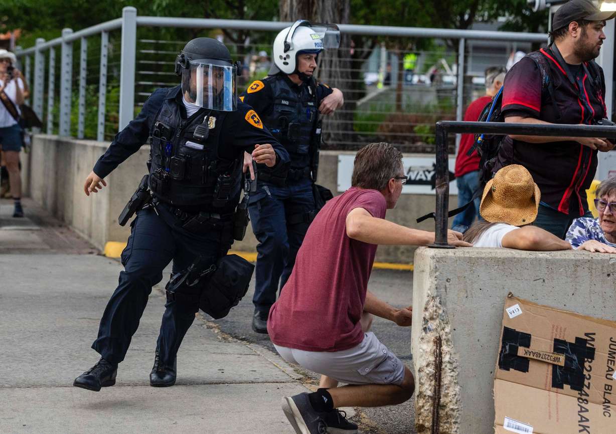Police rush to respond to a reported shooting during a “No Kings” protest and march in Salt Lake City on June 14.