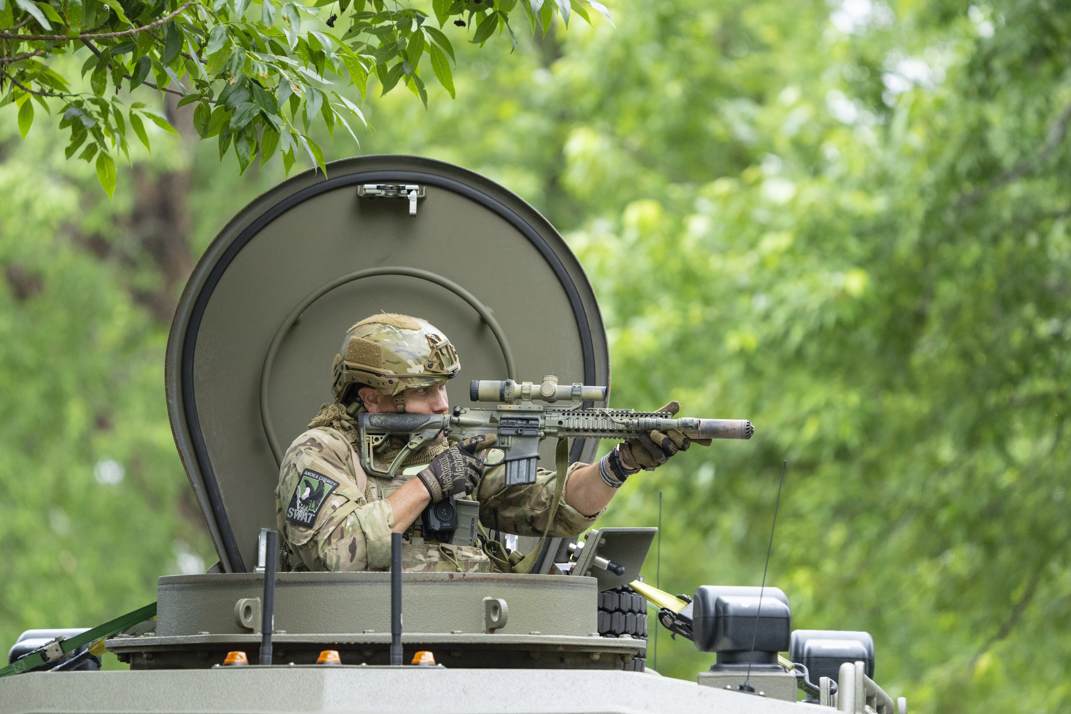 An FBI agent takes part in the search for an active shooter who killed Minnesota State Rep. Melissa Hortman and her husband in Brooklyn Park, Minn., Saturday. A gunman killed the Hortmans Saturday in an apparent "politically motivated assassination."