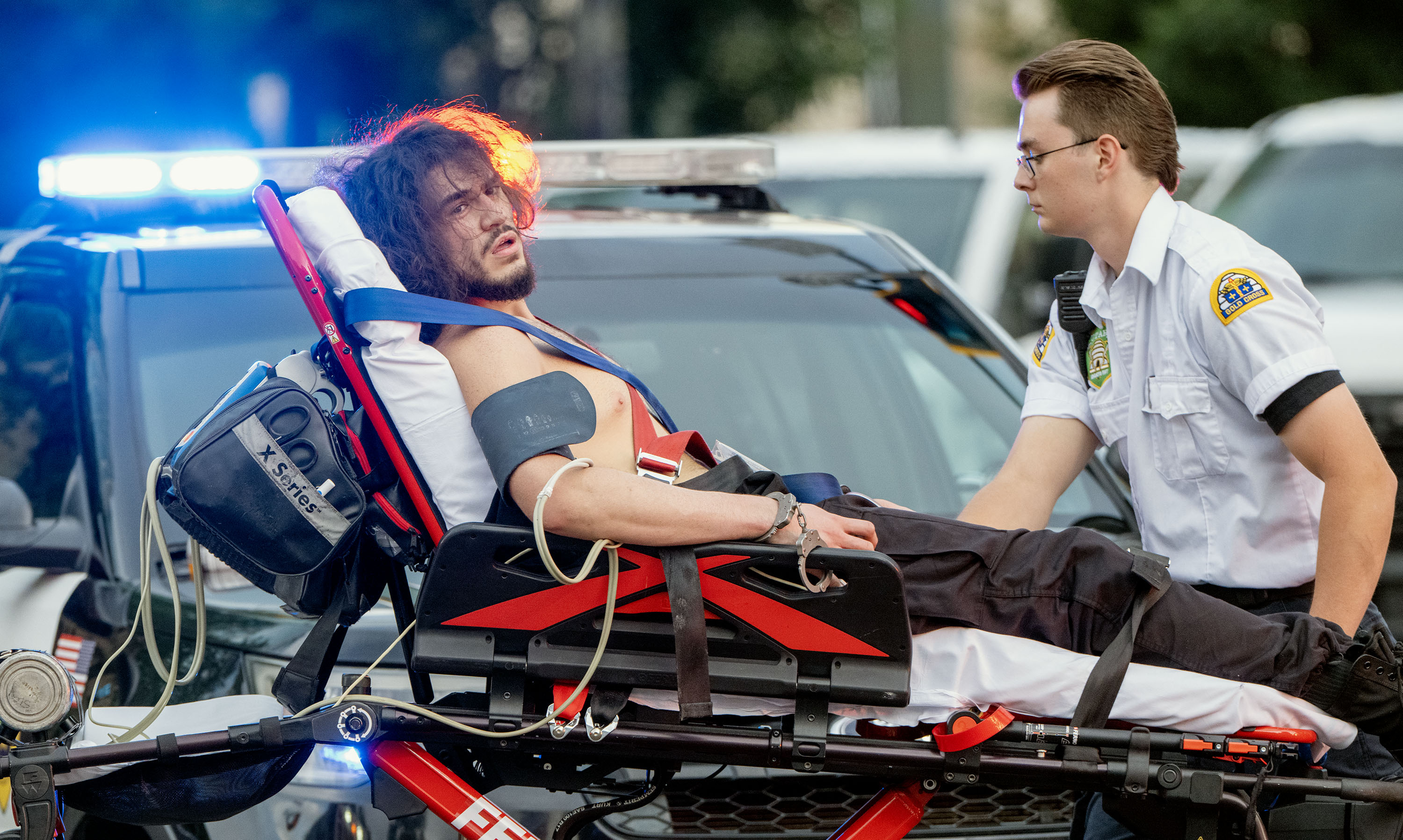 Arturo Gamboa is taken away in handcuffs on a gurney. He was shot during the “No Kings” protest and march in Salt Lake City on June 14.