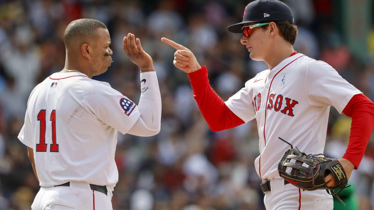 Boston Red Sox's Roman Anthony, right, celebrates with designated hitter Rafael Devers (11) after defeating the New York Yankees in a baseball game, Sunday, June 15, 2025, in Boston.