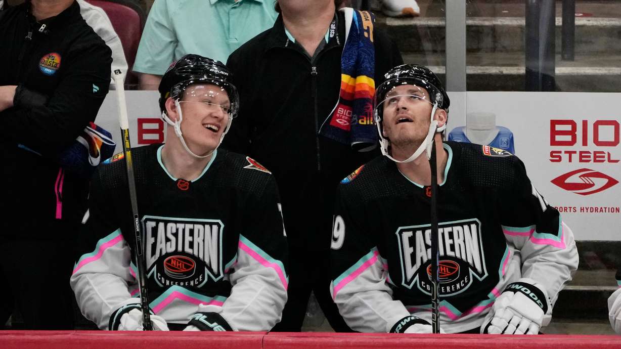FILE - Atlantic Division's Brady Tkachuk, of the Ottawa Senators (7) and Matthew Tkachuk, of the Florida Panthers (19) watch the rerun of a goal by Matthew assisted by Brady during the NHL All Star hockey game, Feb. 4, 2023, in Sunrise, Fla.