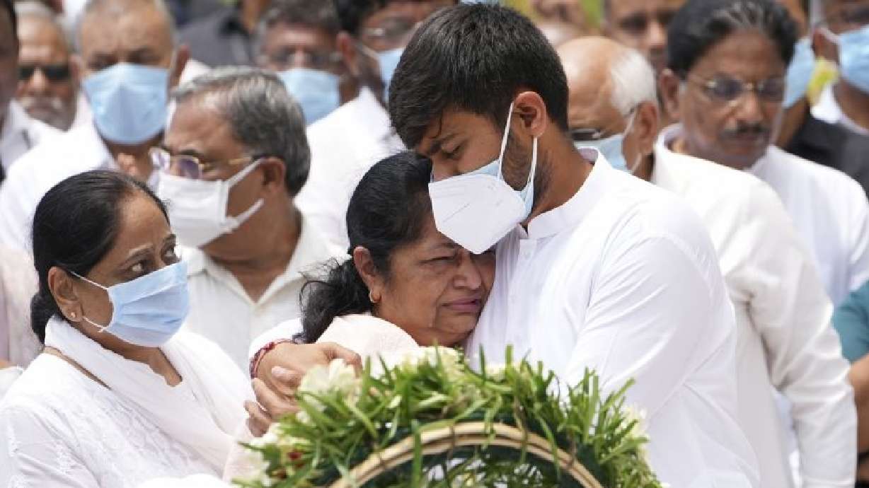 Rushabh Rupani, son of former Chief Minister of Gujarat Vijay Rupani, consoles his mother Anjali Rupani as they receive the body of Vijay Rupani, who died in the June 12 Air India plane crash on in Ahmedabad, India, Monday.