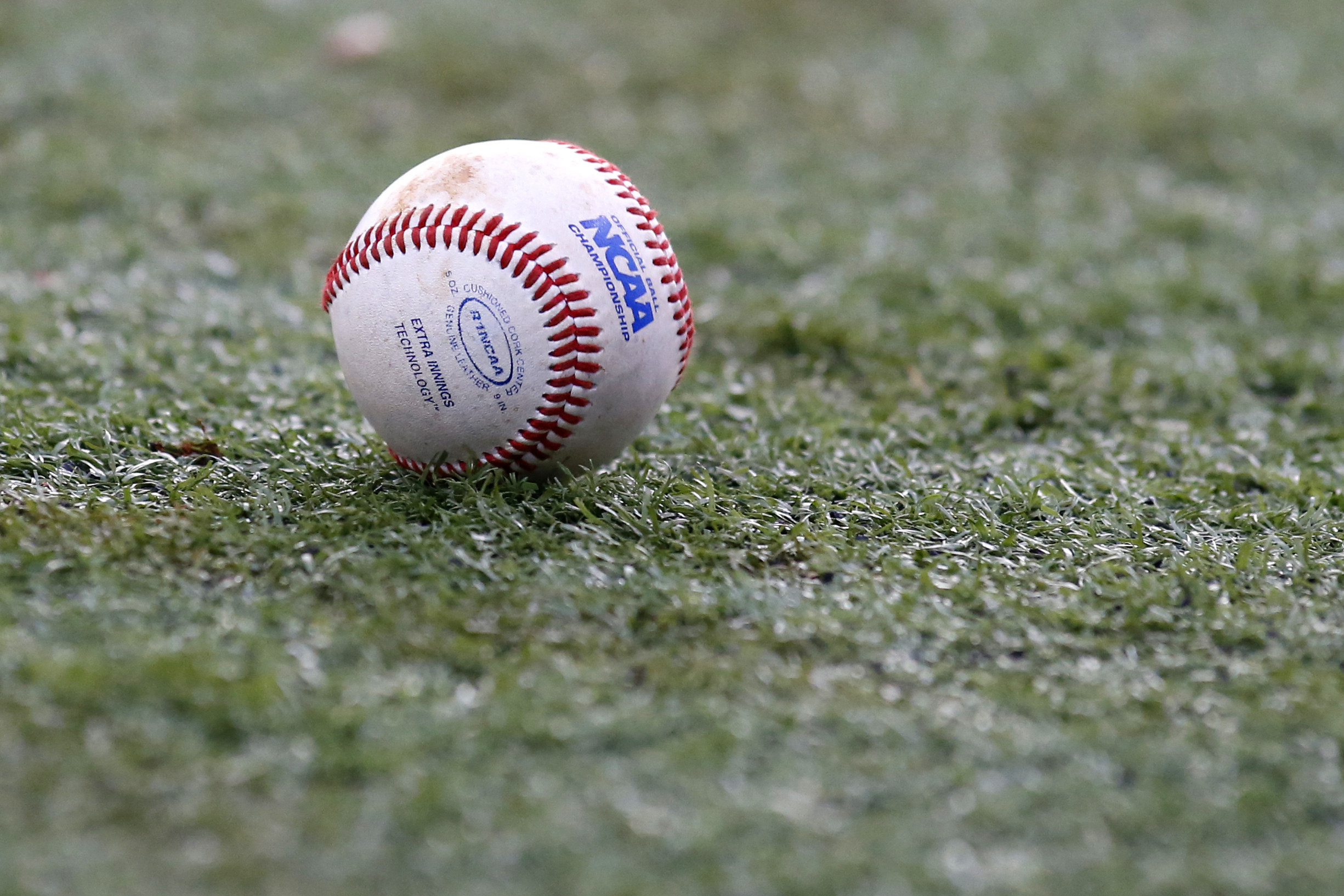 FILE - The NCAA logo is seen on a baseball during an NCAA college baseball tournament regional game between Louisiana-Lafayette and Mississippi State in Lafayette, La., Monday, June 2, 2014.