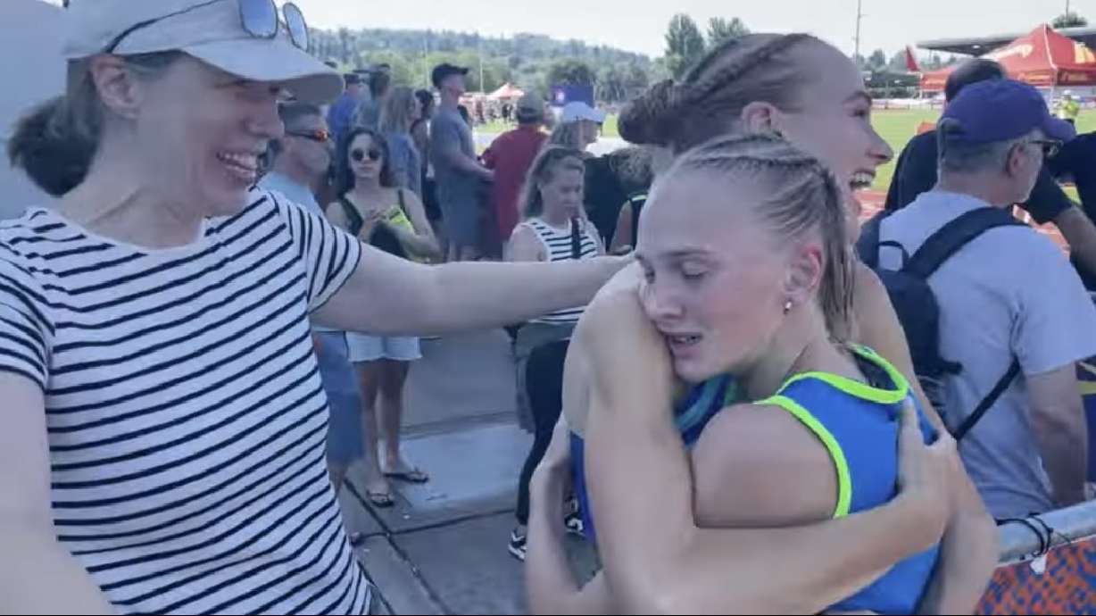 Jane and Susan Hendengren embrace after a race.