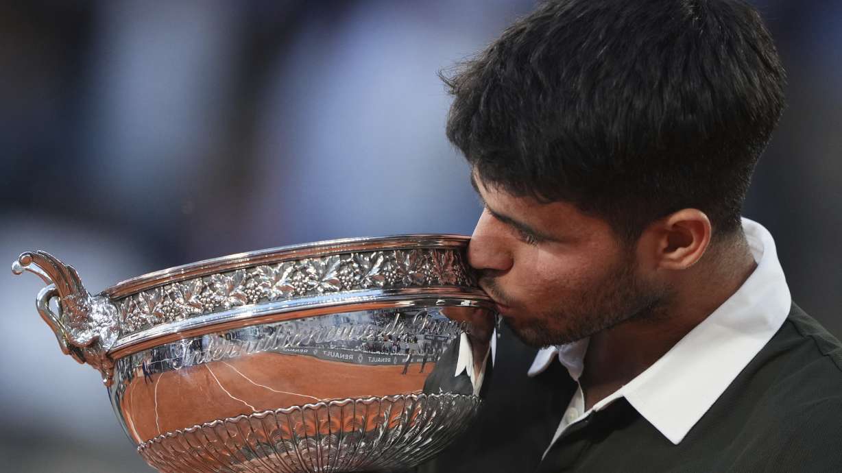 Spain's Carlos Alcaraz celebrates with the trophy after winning the final match of the French Tennis Open against Italy's Jannik Sinner at the Roland-Garros stadium in Paris, Sunday, June 8, 2025.