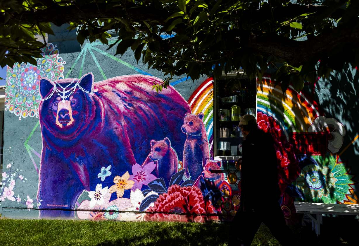 A person walks past Chris Peterson’s "Queen Ursa" mural on Hip and Humble’s store in Salt Lake City on June 4. Peterson said wildlife encounters invoke an "instinctual connection".