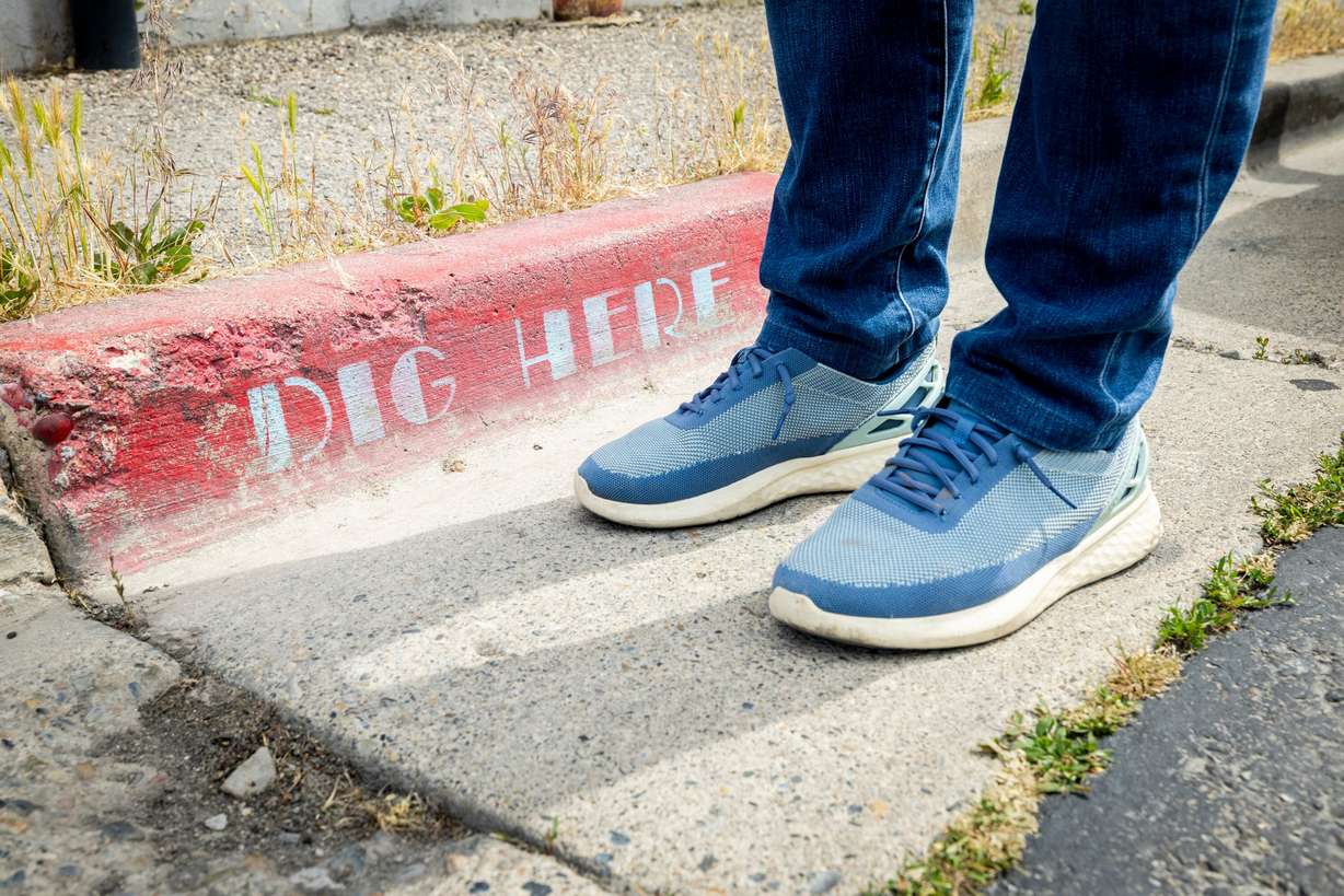 Chris Peterson stands at a specific point where part of his "Space Trout and Utopia Mural Project" appears three-dimensional, in Salt Lake City June 5. Peterson said his eventual goal is to create a mural in each of Utah's counties.