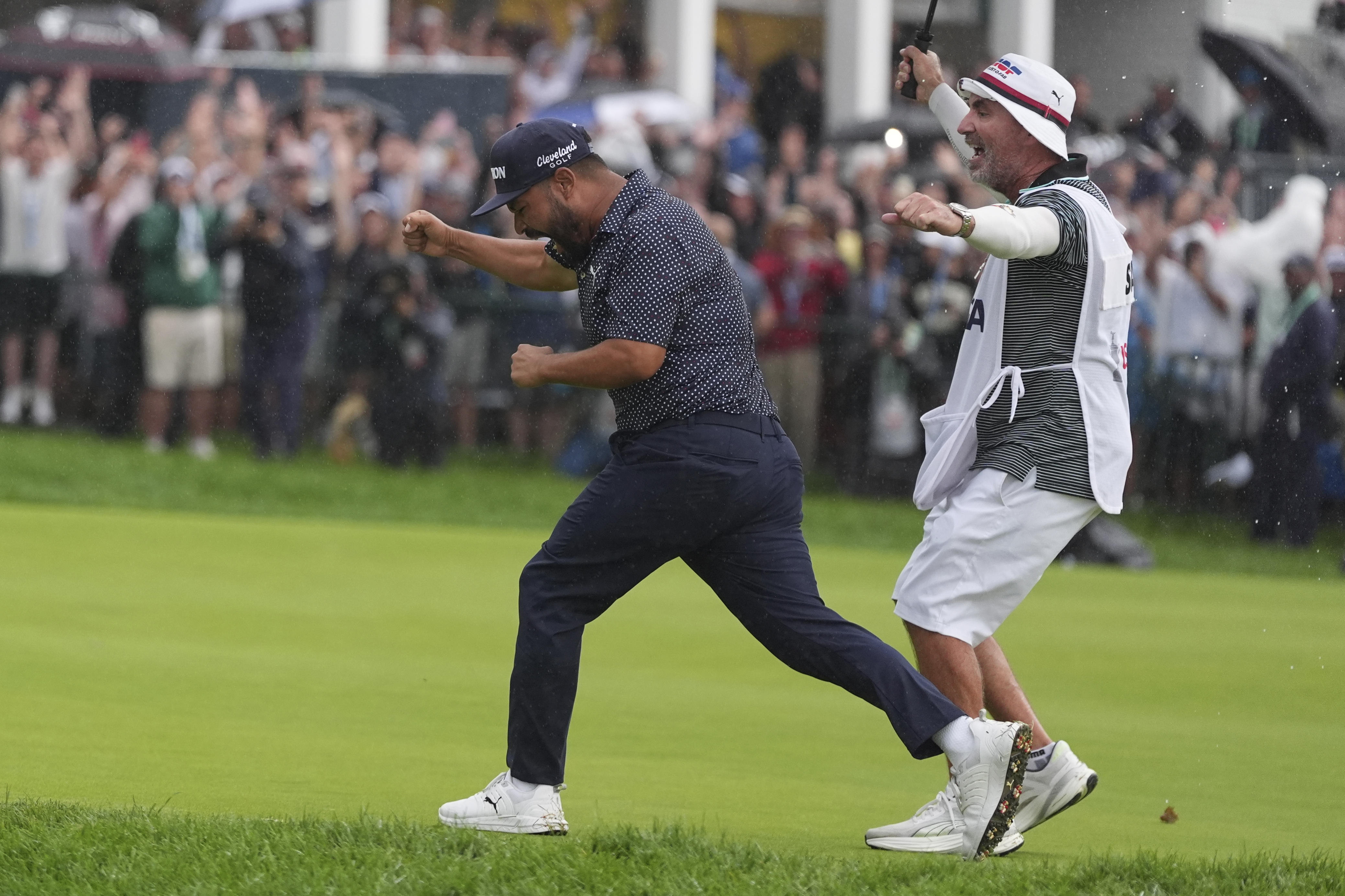 A caddie at heart, Bones Mackay makes sure to get the 18th flag to Spaun's bagman