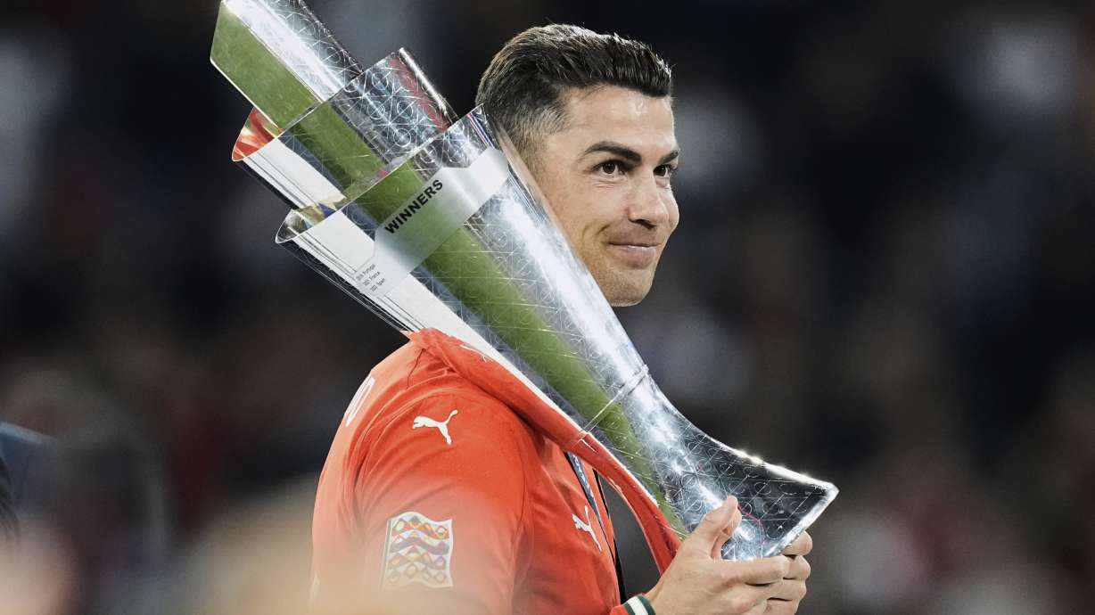 Portugal's Cristiano Ronaldo holds the trophy after winning the Nations League soccer championship at the Allianz Arena in Munich, Germany, Sunday, June 8, 2025.