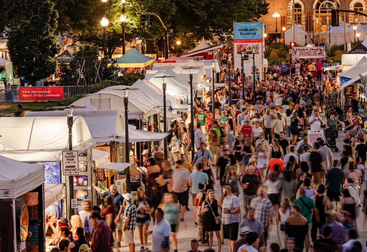 Attendees walk through the artist marketplace at the Utah Arts Festival.