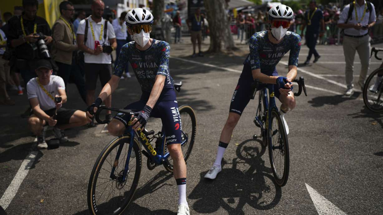 Denmark's Jonas Vingegaard and teammate Matteo Jorgenson, of the U.S., wear face masks at the Tour de France in Saint-Lary-Soulan Pla d'Adet, France, July 13, 2024. A new COVID-19 variant may be causing "razor blade" sore throats.