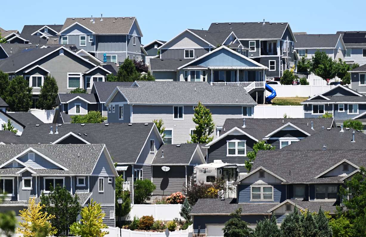 Homes and "for sale" signs in are pictured in the Salt Lake Valley on June 18, 2024. Nearly half of Utahns won't make a major purchase this year — like buying a home — because of President Donald Trump's tariffs, a new Deseret News/Hinckley Institute of Politics poll found Wednesday.