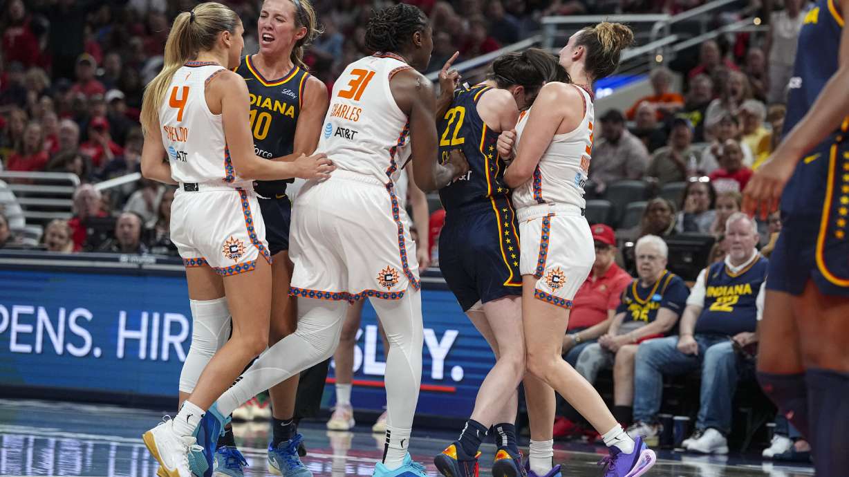 Indiana Fever guard Caitlin Clark (22) is hit by Connecticut Sun guard Marina Mabrey (3) during a scuffle in the second half of a WNBA basketball game in Indianapolis, Tuesday, June 17, 2025.