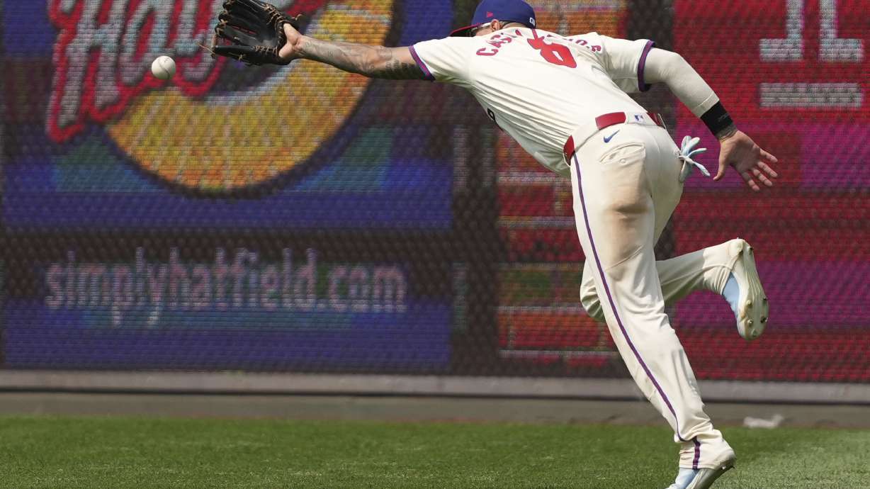 Philadelphia Phillies right fielder Nick Castellanos can't reach a triple hit by Chicago Cubs' Ian Happ during the eighth inning of a baseball game Wednesday, June 11, 2025, in Philadelphia.