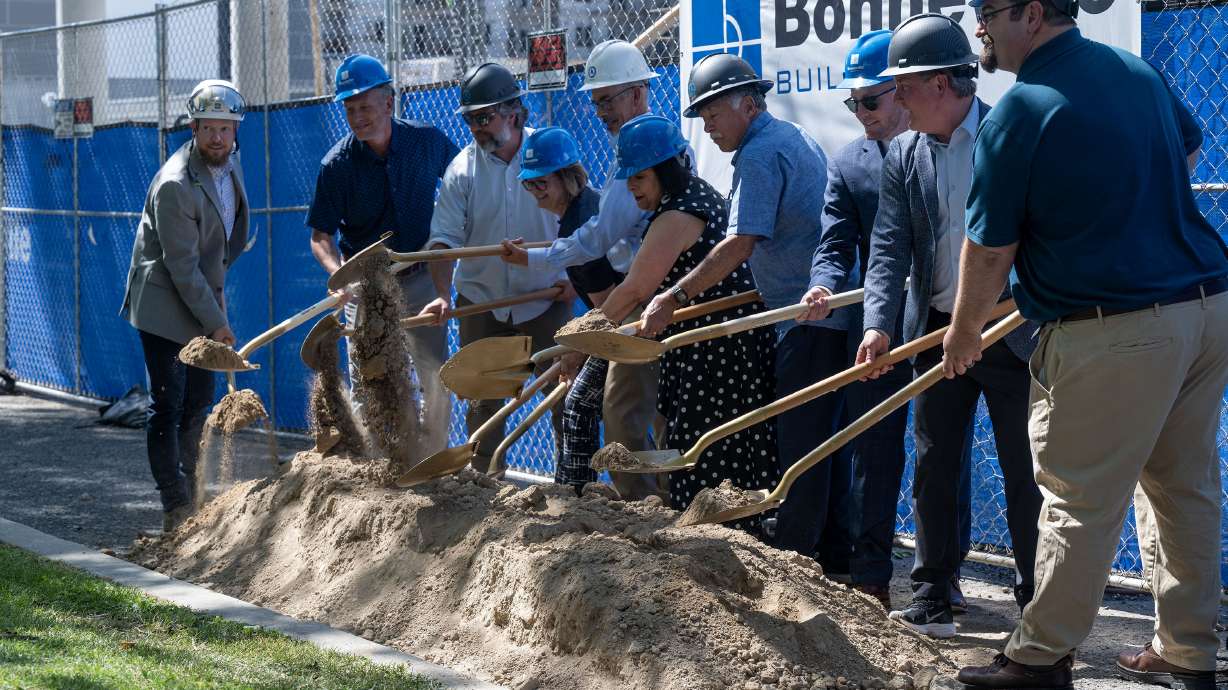 Officials turn over dirt as Housing Connect and First Step House hold a ceremonial groundbreaking of 44 North, an affordable housing development in Salt Lake City, on Wednesday.