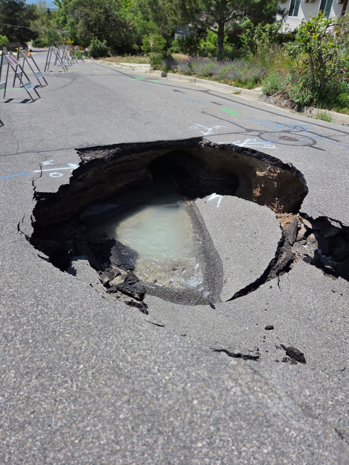 A sinkhole is pictured on Nila Way in Holladay. Two sinkholes have appeared in the area in the past two weeks.
