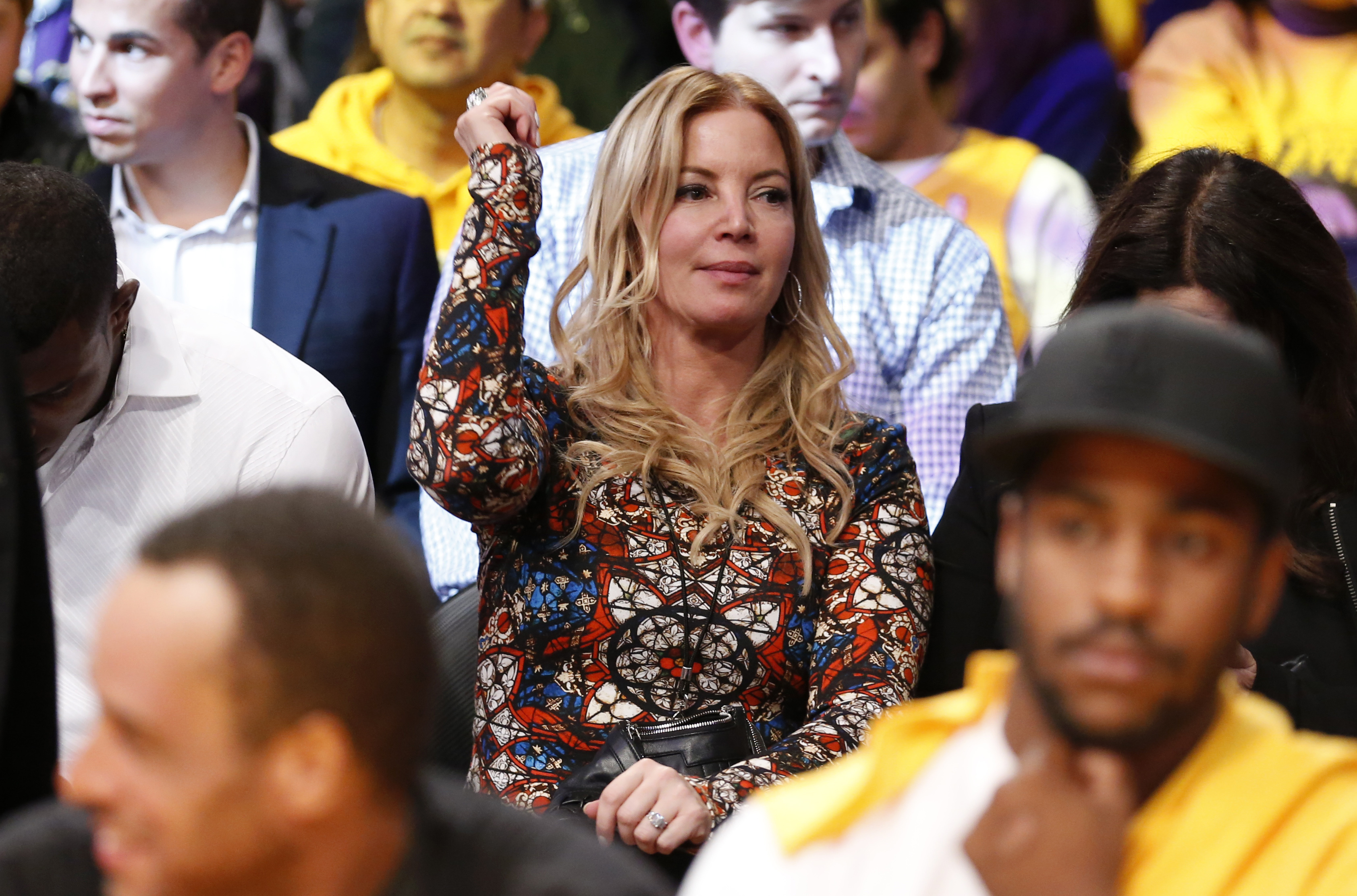 FILE - Los Angeles Lakers President Jeanie Buss dances in her seat to music as she attends the NBA basketball game between the Lakers and the Los Angeles Clippers in Los Angeles, Oct. 29, 2013.