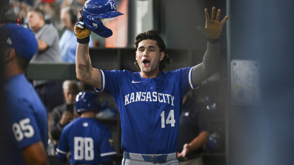 Kansas City Royals' Jac Caglianone celebrates in the dugout after hitting his first career home run during a baseball game against the Texas Rangers, Thursday, June 19, 2025, Arlington, Texas.