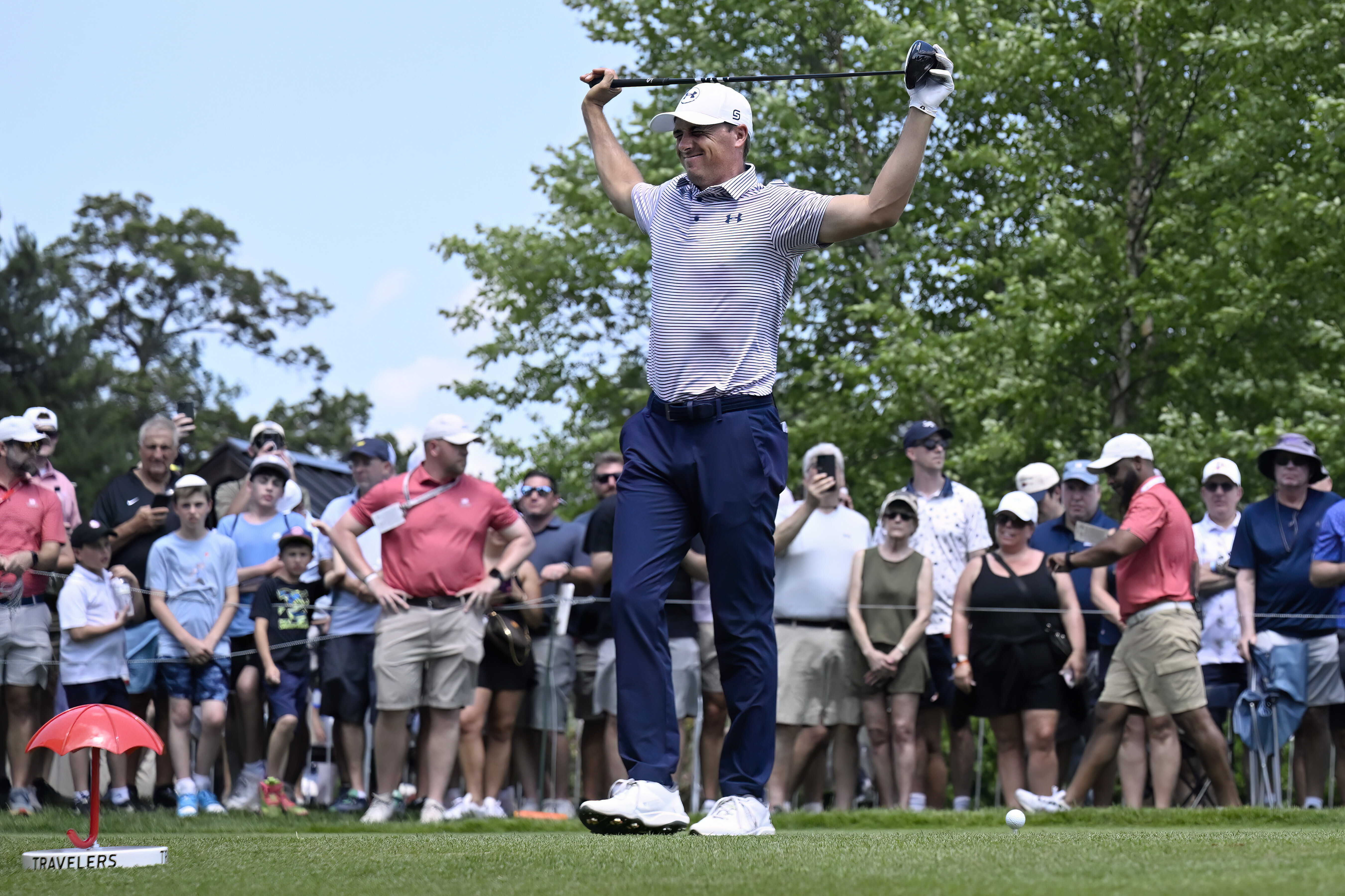 Jordan Spieth stretches at the first hole during the first round of the Travelers Championship golf tournament at TPC River Highlands, Thursday, June 19, 2025, in Cromwell, Conn.